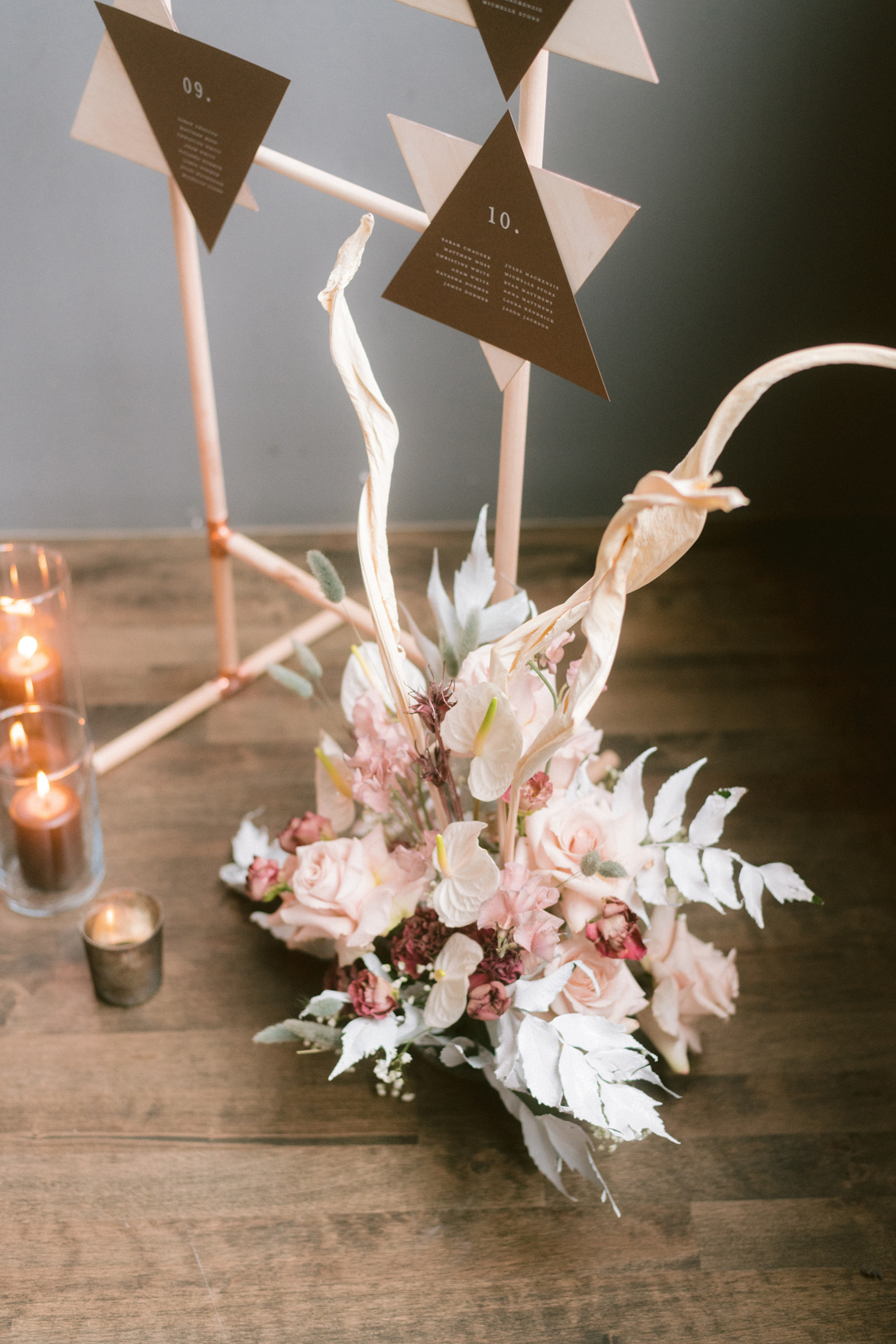 Wedding decor with a pastel bouquet and candles on the floor next to the wedding registry