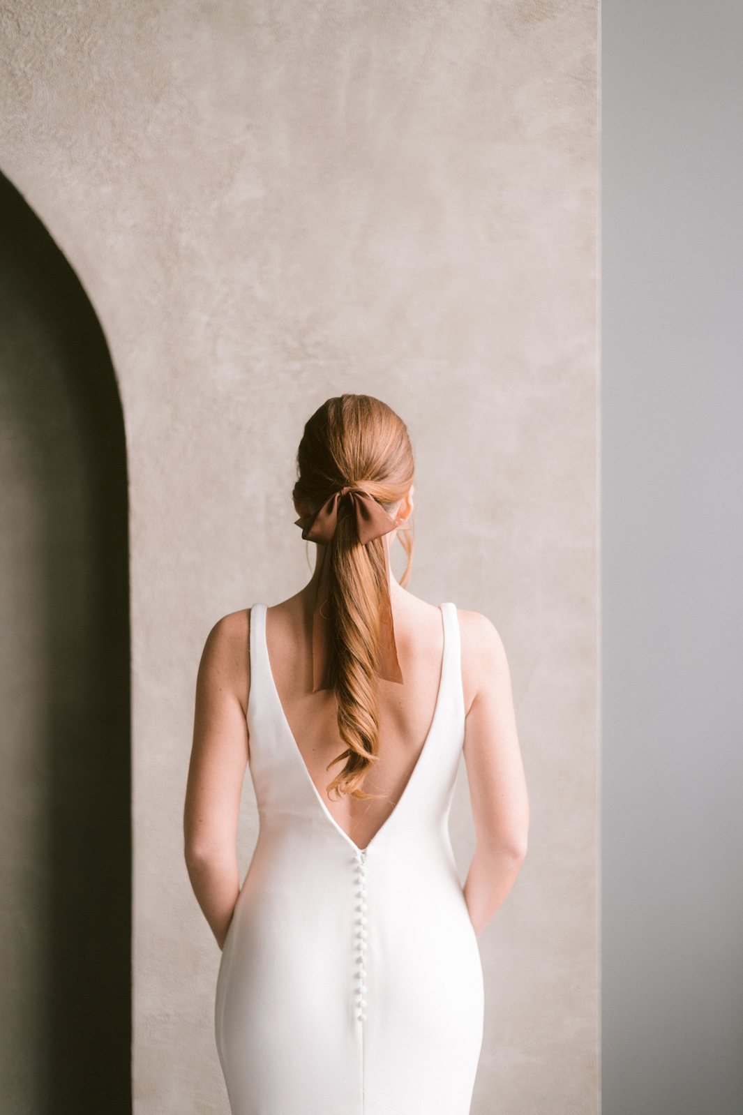 Bride in a white dress facing back